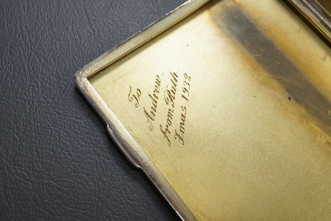 A George V engine turned silver mounted cigarette box, London, 1934, 17.6cm, together with a similar engine turned silver cigarette case.